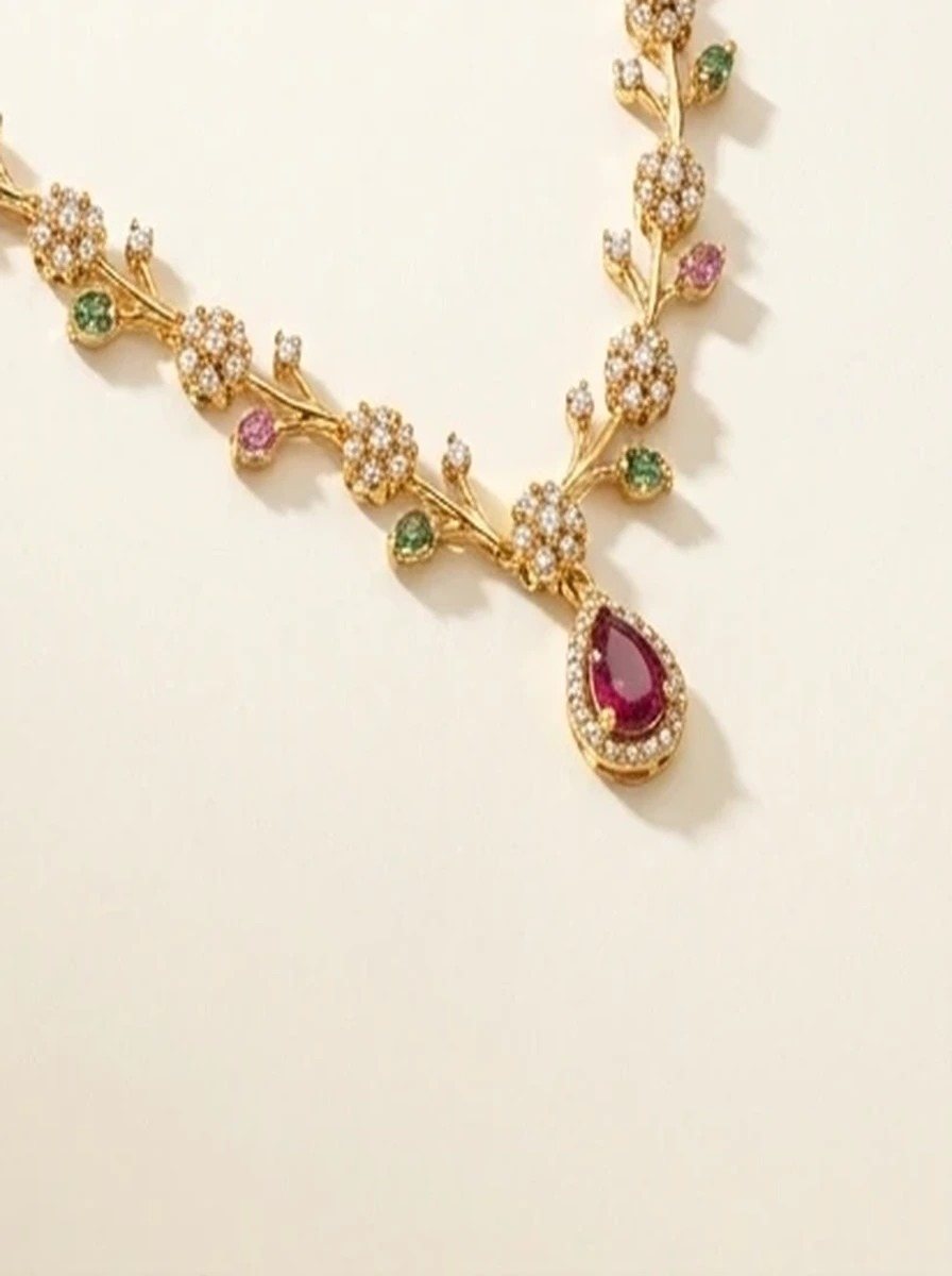 Macro close-up of the red teardrop pendant and its stone halo